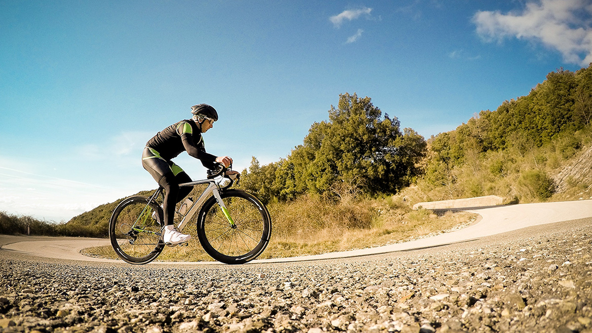 How To Improve Your Strength To Weight Ratio Image Of A Cyclist Riding Uphill To Improve Their Strength To Weight Ratio And Power To Weight Ratio