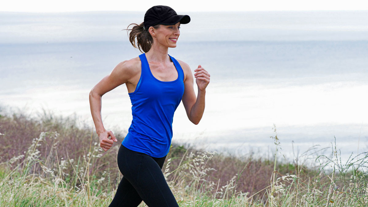 Image Of A Woman Running By The Sea Doing Base Training