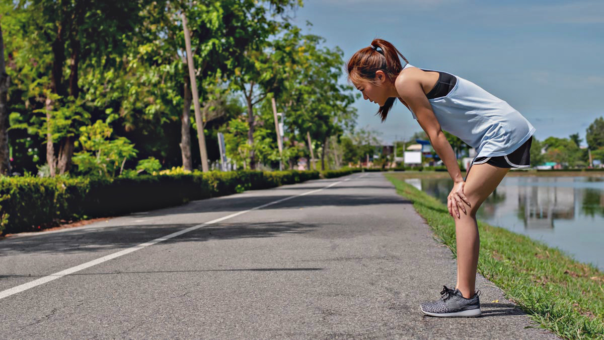 Asian Women Exercising. She Is Running On The Street, She Is Tir Asian Women Exercising. She Is Running On The Street, She Is Tir