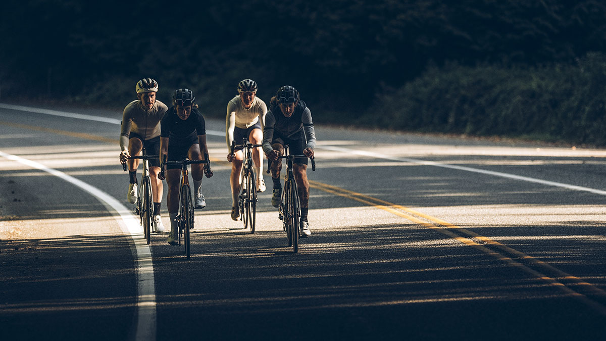 A Group Of Men And Women On A Training Ride To Prepare For A Race.