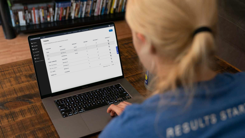 Coach looking at Laptop screen with Payments UI